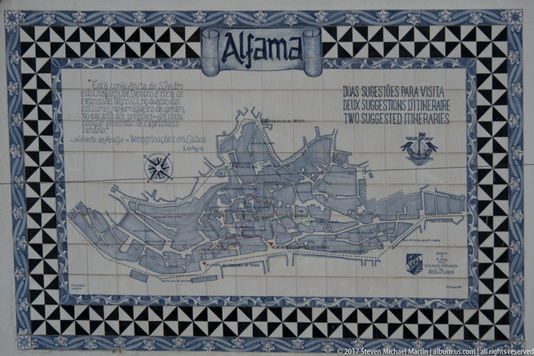 Decorative tiled map labeled 'Alfama' with streets, landmarks, and suggested visitor itineraries.