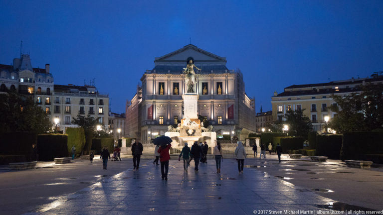 Teatro Real illuminated at blue hour behind the fountain and equestrian monument to Philip IV in Plaza de Oriente.