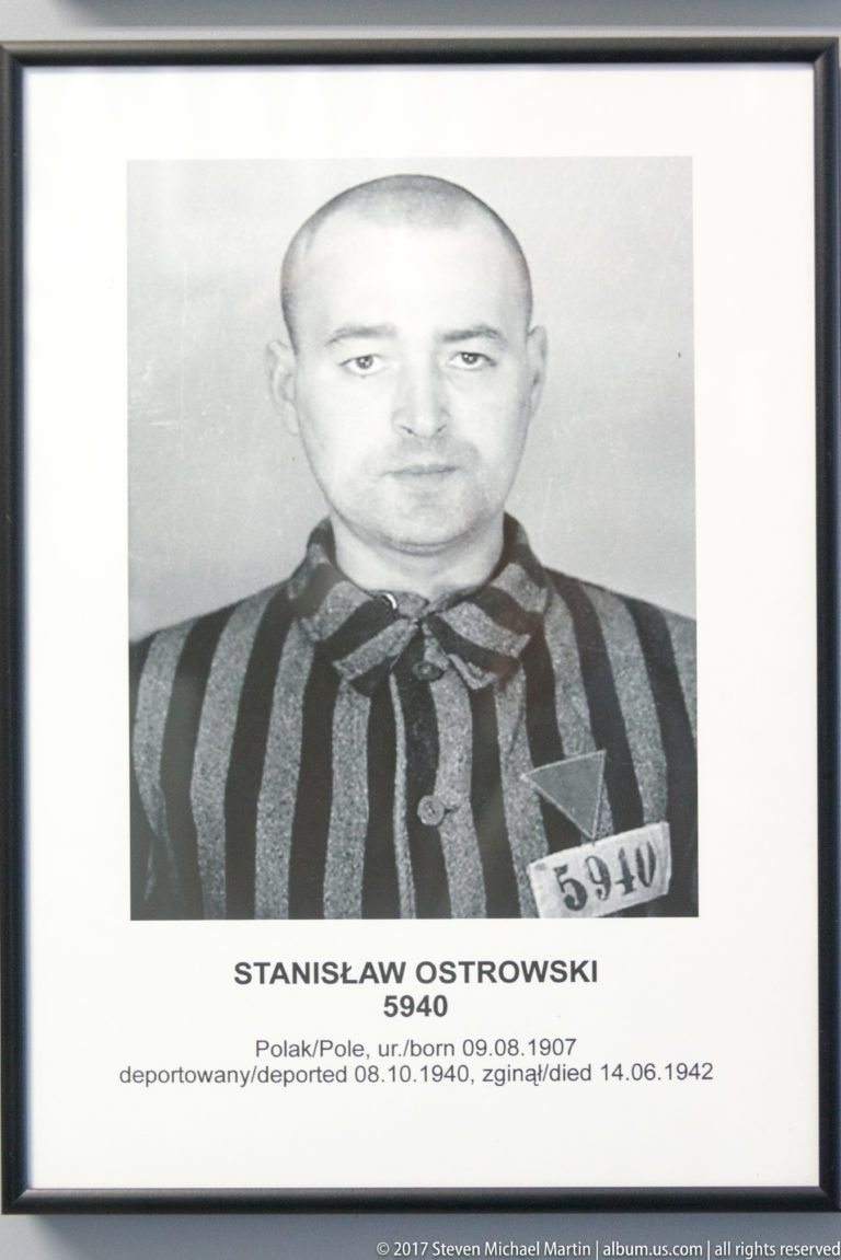 Framed portrait of Stanisław Ostrowski in striped prisoner uniform, identified as Auschwitz prisoner 5940.