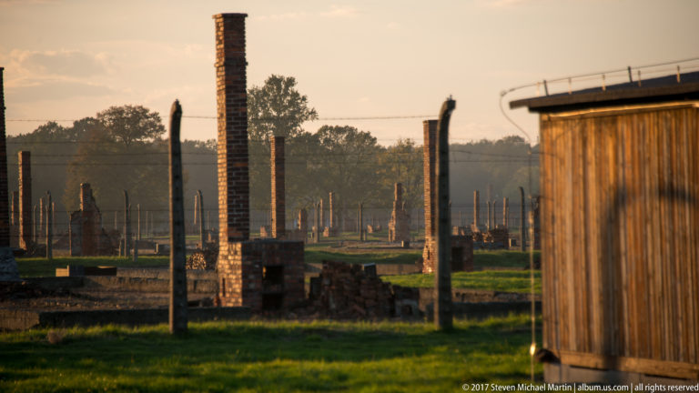 Numerous brick chimneys and ruined barrack foundations extending across the grounds of Auschwitz II-Birkenau.
