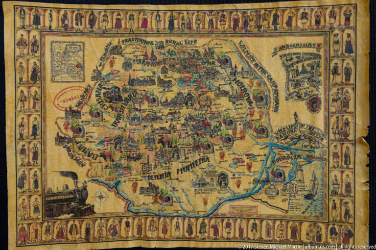 Colorful illustrated map of Romania filled with villages, people, buildings, landscapes, and a border of traditional figures.
