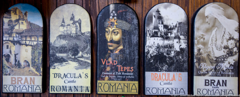 Row of souvenir magnets featuring Bran Castle, Vlad Tepes, Dracula imagery, and Queen Marie references.