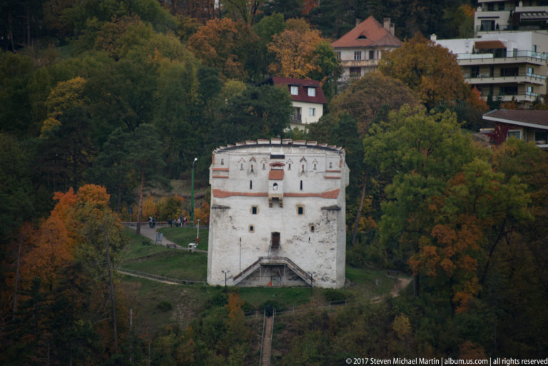 White Tower, Turnul Alb, standing on a wooded autumn hillside above Brașov.