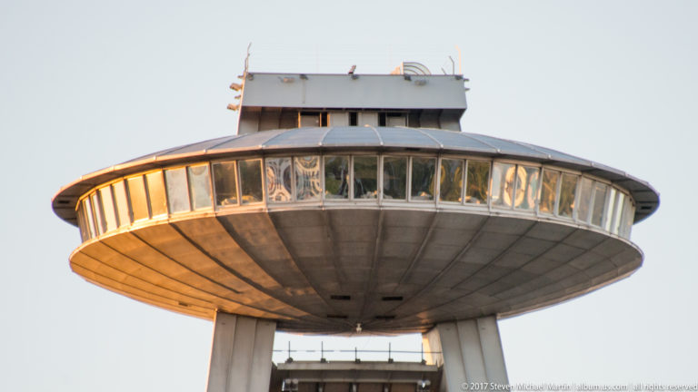 Close upward view of the circular UFO observation deck and window band atop the Most SNP bridge.