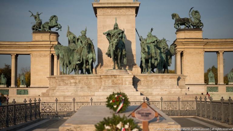 Bronze mounted Magyar chieftains at the base of the Millennium Column with commemorative wreaths in front.
