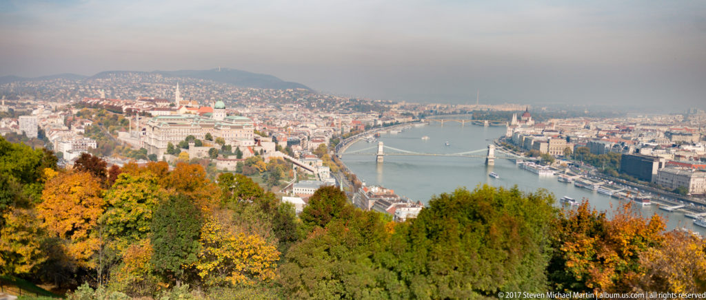 Autumn panorama from Gellért Hill over Buda Castle, Chain Bridge, the Danube, and central Pest.