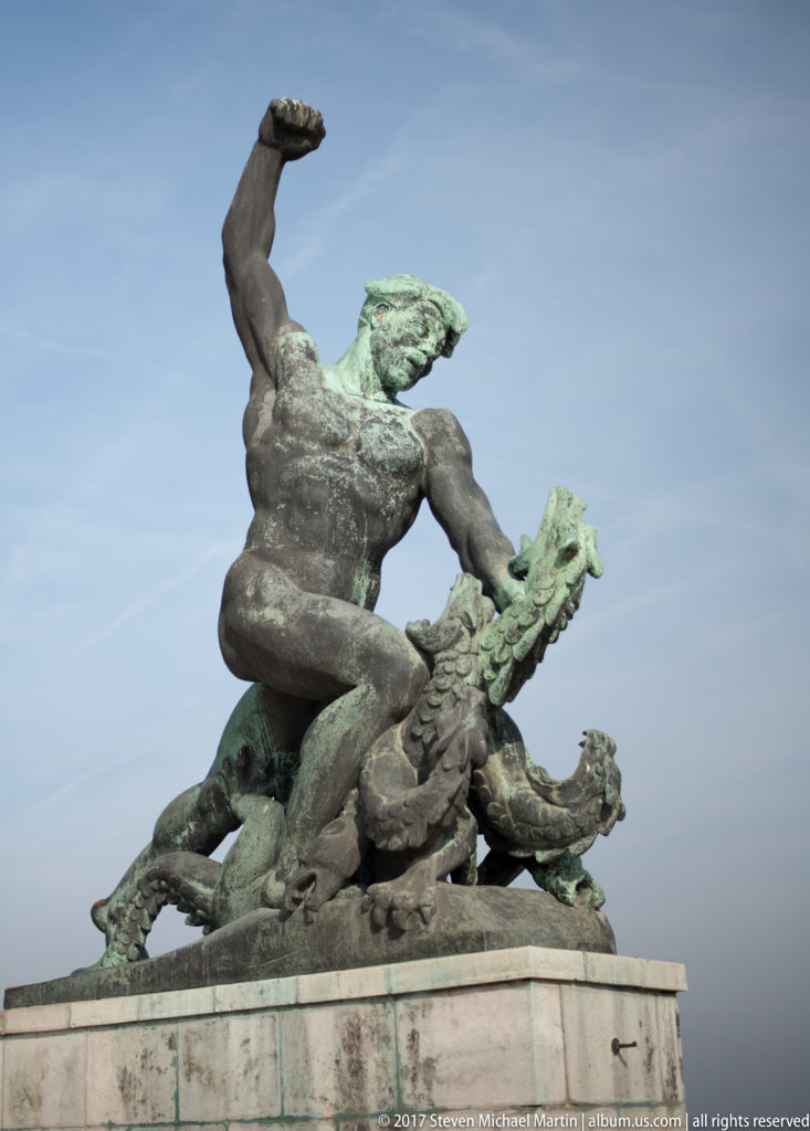 Dynamic patinated bronze male figure with one arm raised in the Liberty Statue monument complex on Gellért Hill.