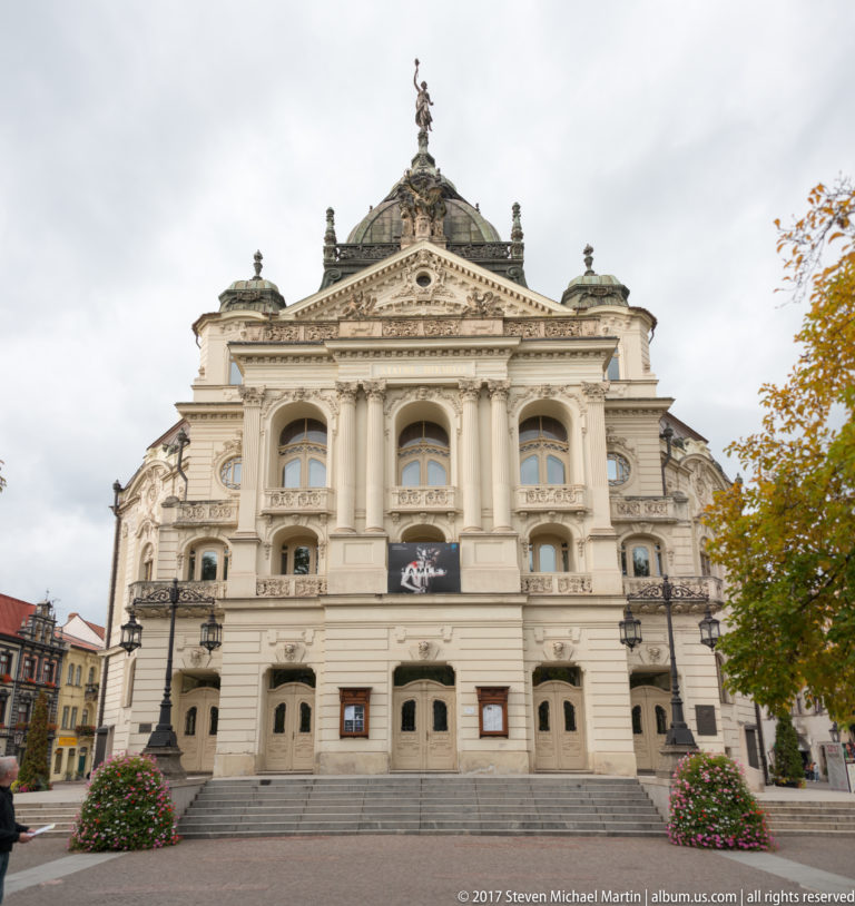 Front view of the State Theatre in Košice with broad steps, arched openings, paired columns, balconies, and domed roof.