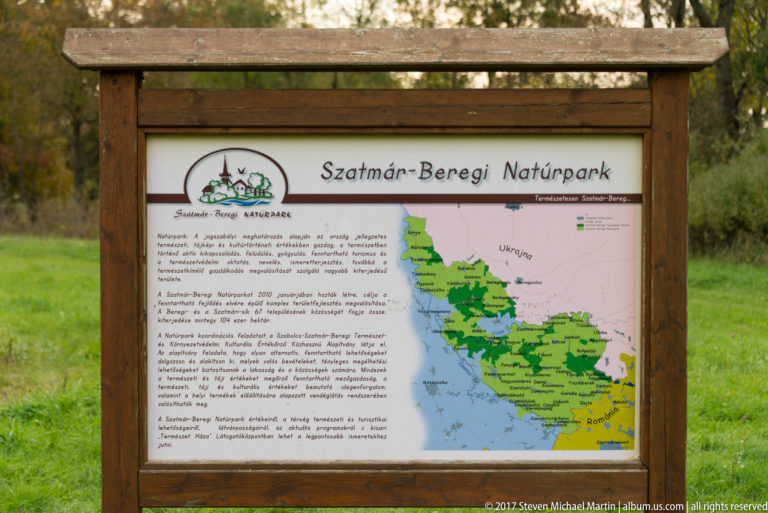 Wood-framed Szatmár-Beregi Natúrpark information board with Hungarian text and a green regional map.
