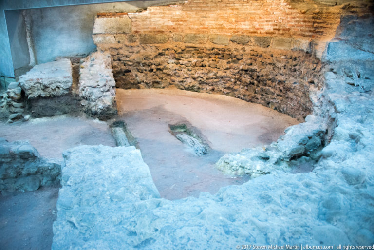 Excavated stone foundations and brick masonry forming low walls at the ancient Serdica archaeological complex in Sofia.