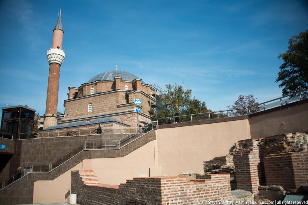 Banya Bashi Mosque and minaret behind excavated brick and stone walls at the Serdica archaeological area.