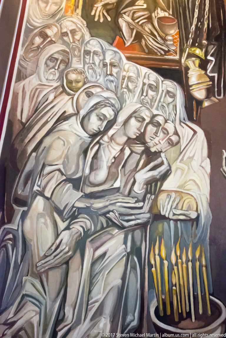 Teofan Sokerov mural with crowded seated figures, vessels, gesturing hands, and a row of yellow candles.