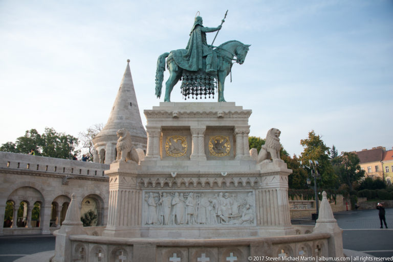 Bronze equestrian statue of Saint Stephen I on a carved stone pedestal with lions, backed by Fisherman’s Bastion.