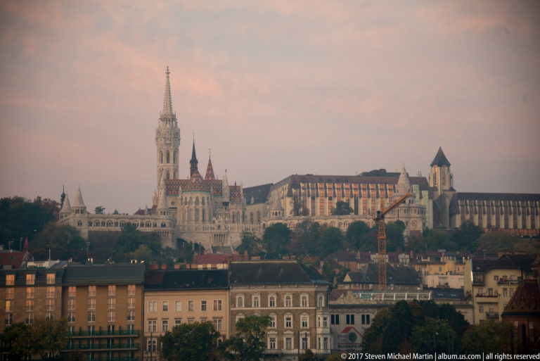 Matthias Church and Fisherman’s Bastion crown Castle Hill above rows of Buda buildings in a broad city view.