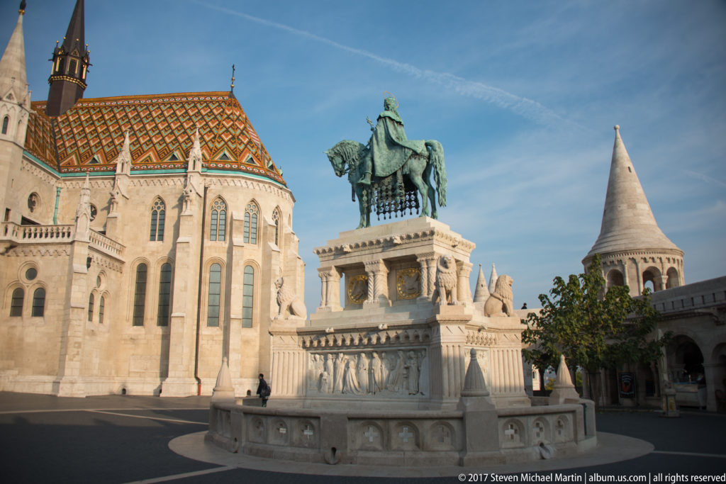 Saint Stephen I equestrian monument between Matthias Church’s patterned apse and a conical Fisherman’s Bastion turret.