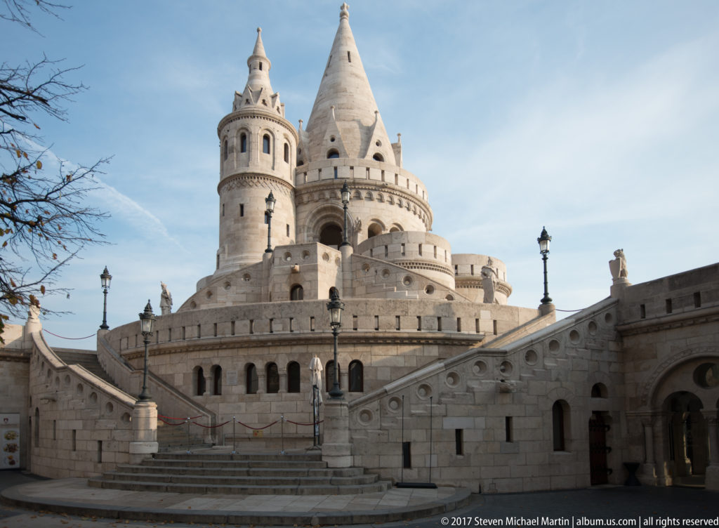 Paired conical towers above a curved gallery and central stair at Fisherman’s Bastion in Budapest.