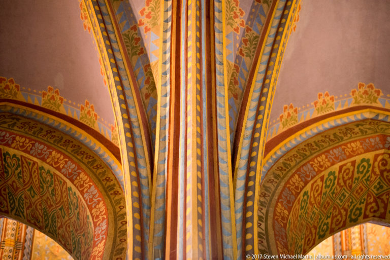 Close view of polychrome ribs and arches with striped, geometric, and foliate painted patterns inside Matthias Church.