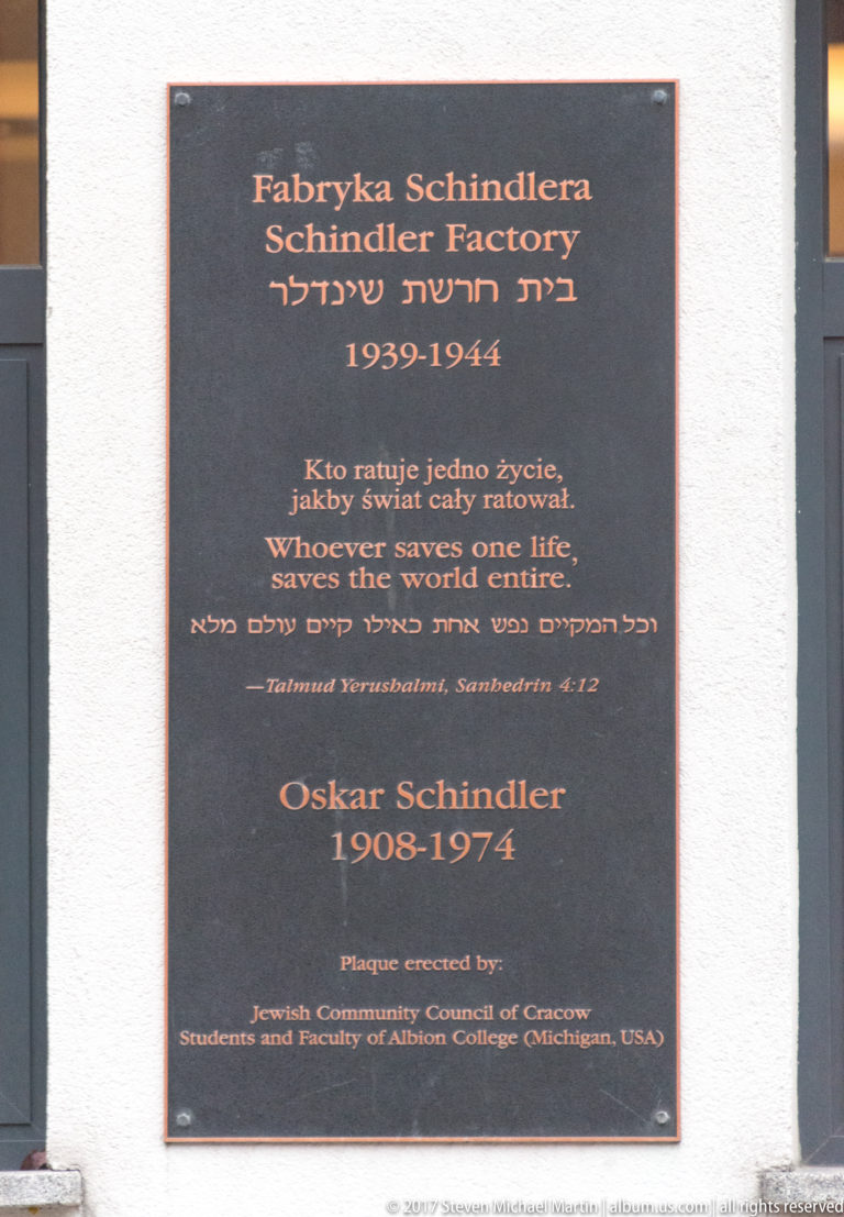 Memorial plaque at Schindler’s Factory with Polish, English, and Hebrew text, Talmud quotation, and Oskar Schindler’s dates 1908–1974.