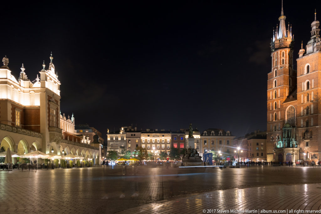 Night view across Krakow’s Main Market Square toward the Cloth Hall at left and St. Mary’s Basilica at right.
