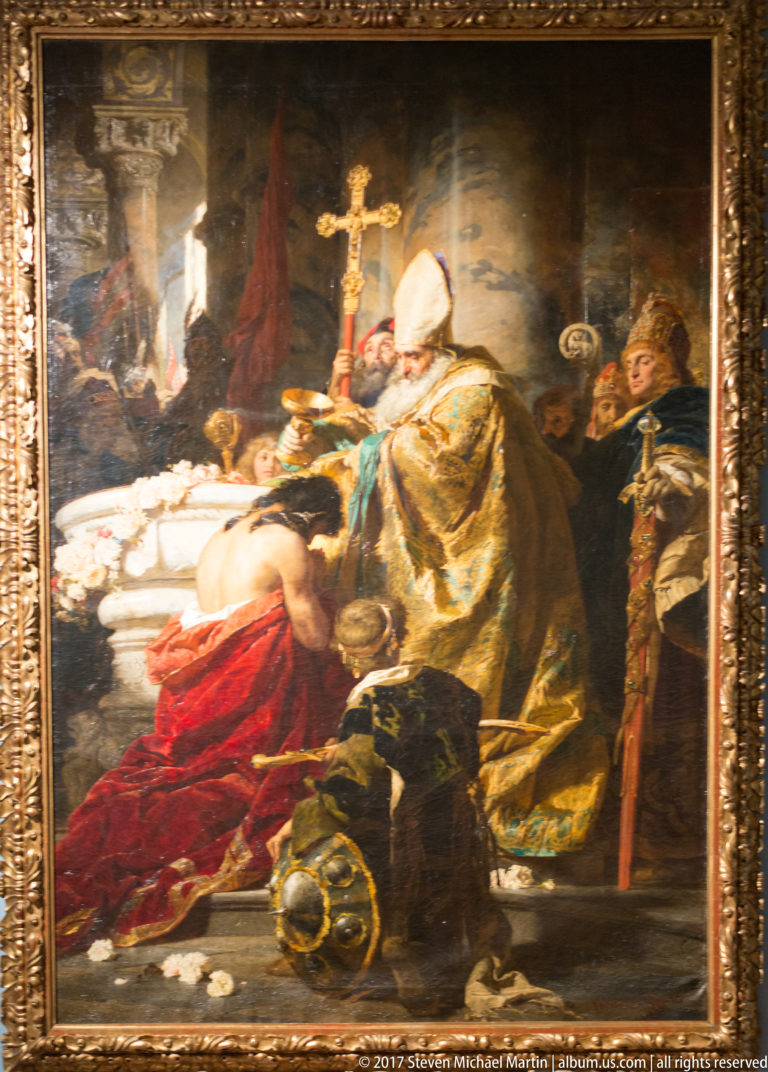 Large framed painting of a richly robed cleric beside a recumbent figure, with a crucifix and attendants.