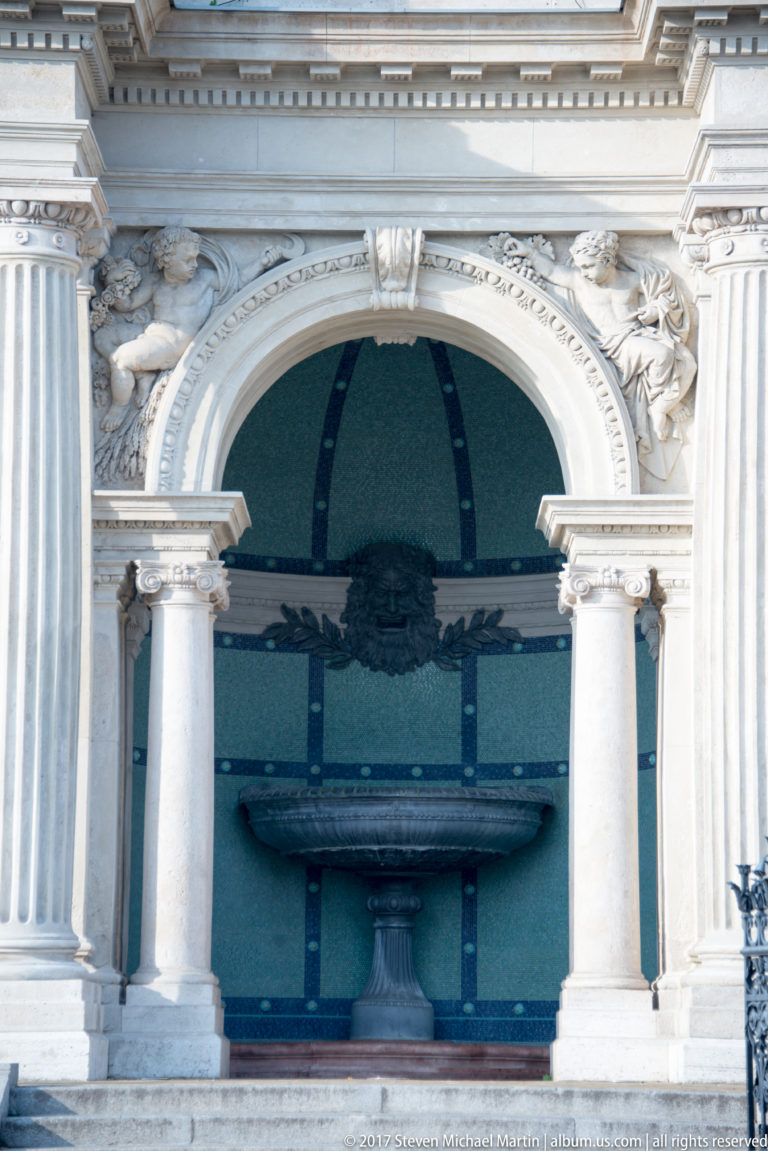 Stone fountain basin inside an arched niche with columns and carved ornament at the Castle Garden Bazaar.