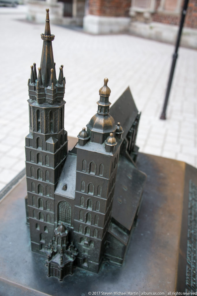 Bronze tactile model of St. Mary’s Basilica showing its unequal towers, roof forms, and elongated church body.