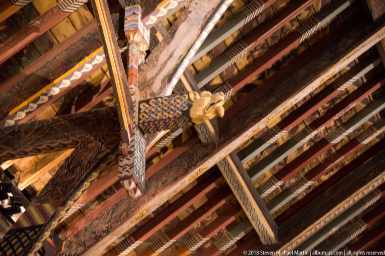 Oblique upward view of painted rafters and braces with patterned decoration and carved projections in Kilkenny Castle’s Picture Gallery.