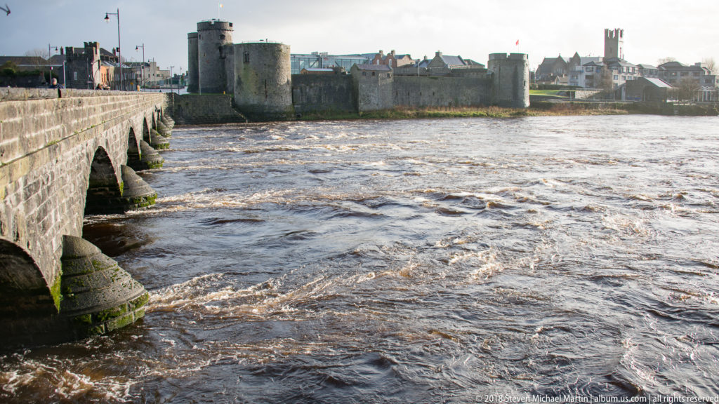 King John’s Castle across the River Shannon with the stone arches of Thomond Bridge entering from the left.