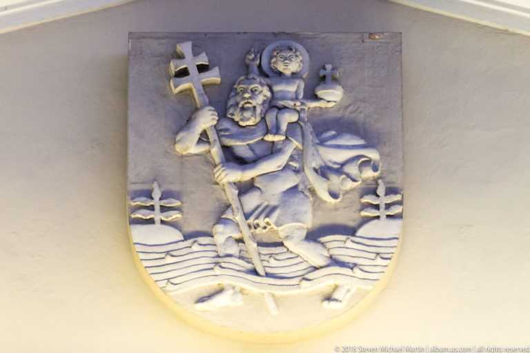Stone relief of Saint Christopher carrying the Christ Child through water, the traditional coat of arms of Vilnius.