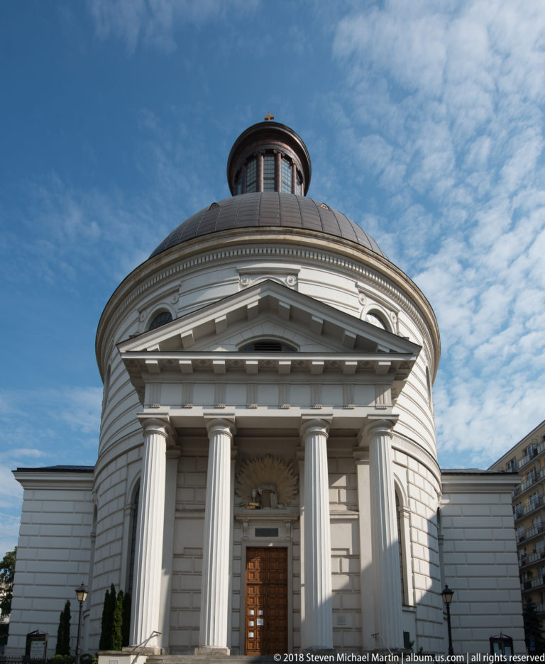 Holy Trinity Lutheran Church with white columned portico, circular walls, and a low domed roof.
