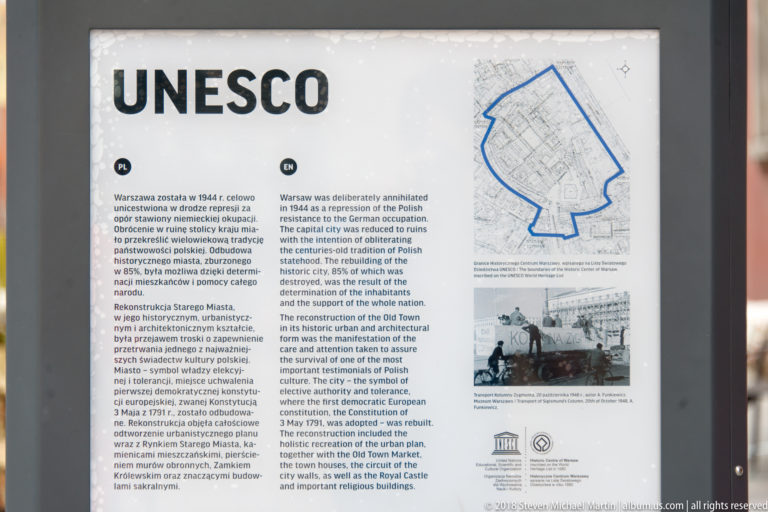 UNESCO panel with bilingual text, map, and archival images explaining Warsaw's reconstructed historic center.