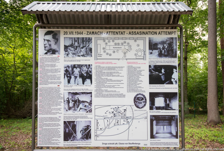 Large outdoor interpretive board about the 20 July 1944 assassination attempt, surrounded by trees at Wolf’s Lair.