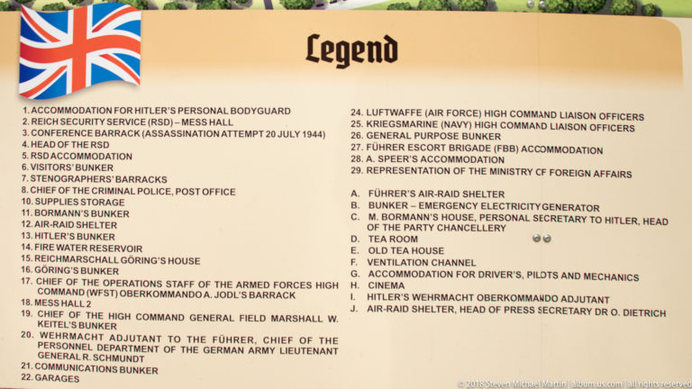 Printed Wolf’s Lair map legend listing numbered bunkers, barracks, shelters, command facilities, garages, and other site functions.