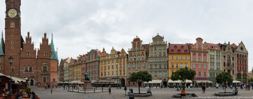Wrocław Market Square with the brick Old Town Hall at left and colorful gabled townhouses lining the square.