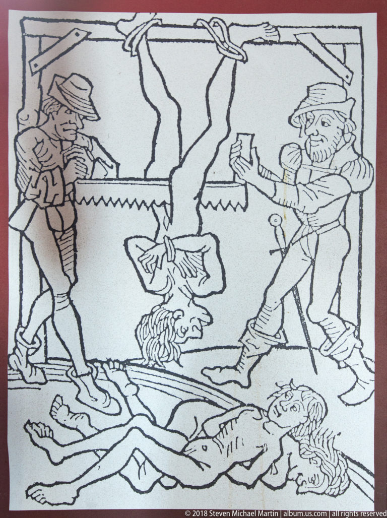 Black-and-white museum illustration showing figures around a violent execution scene with bodies on the ground