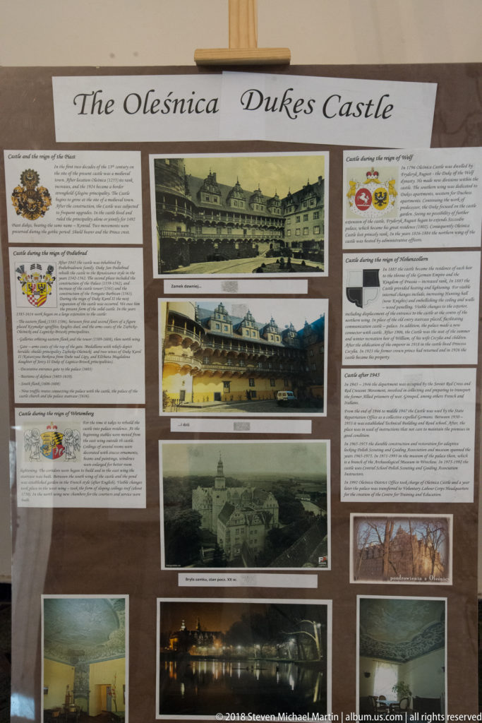 Exhibition display titled Oleśnica Dukes Castle with historic photographs, heraldic emblems, and interpretive text.