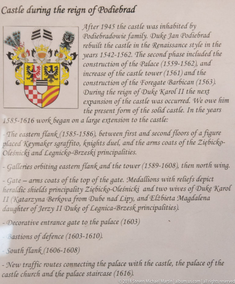 English interpretive panel about the Poděbrady dynasty’s building works at Oleśnica Castle, with a heraldic shield.