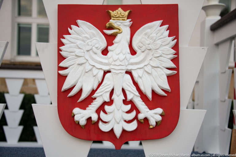 White crowned eagle in relief on a red shield, the national coat of arms of Poland.