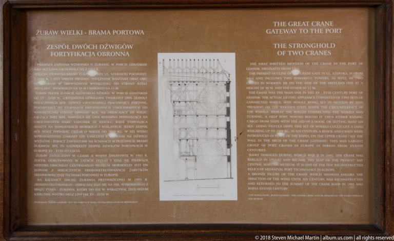 Brown museum panel with Polish and English text titled about the Great Crane, centered on a technical drawing.