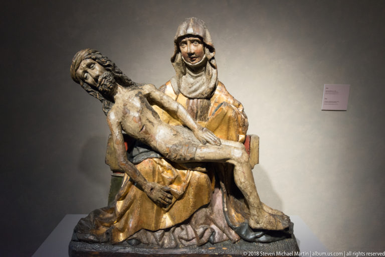 Polychrome Pietà with the seated Virgin Mary supporting the dead body of Christ across her lap.