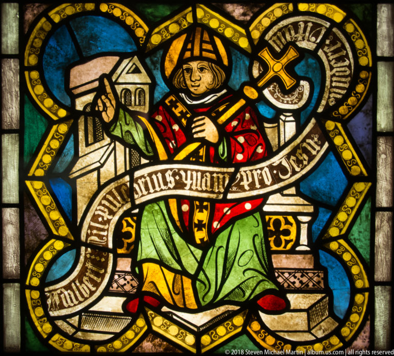 Saint Adalbert of Prague, or Wojciech, seated as a mitred bishop with pastoral staff before stylized church architecture.