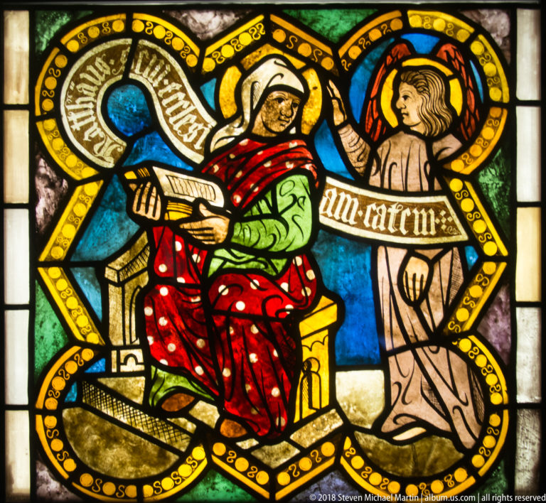 Saint Matthew the Evangelist seated with an inscribed scroll reading Matthaeus beside a second haloed figure.