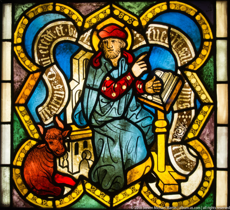 Saint Luke the Evangelist seated with an open book and his ox attribute at lower left.