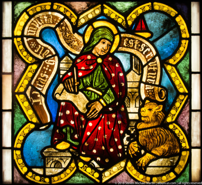 Saint John the Baptist seated beside a lamb with an 'Ecce Agnus' inscription.