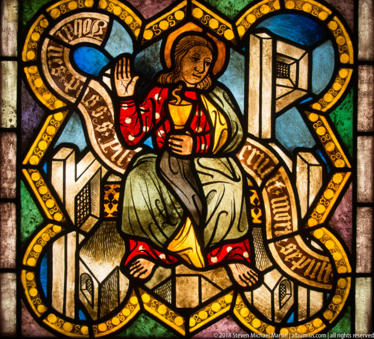 Saint John the Evangelist seated with a chalice and serpent amid stylized architecture.