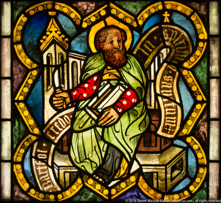 Saint Bartholomew seated with a long knife-like martyrdom attribute and surrounding inscription.