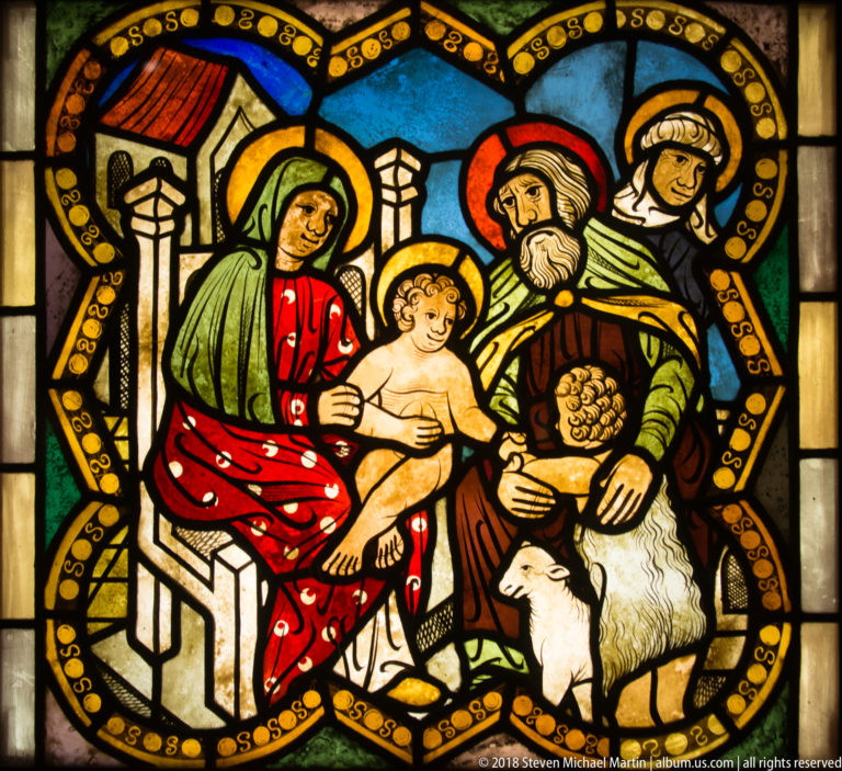 Haloed woman holding the nude Christ Child beside a bearded saint with a lamb and another haloed woman.