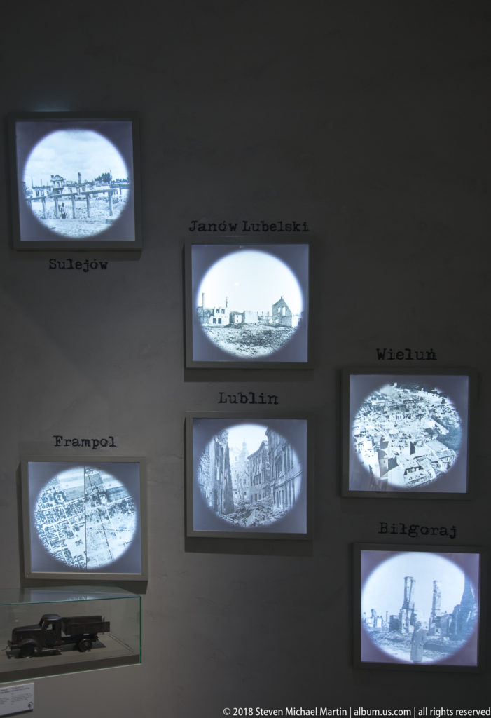 Wall of small oval aerial photographs labeled with European city names including Lublin, Wieluń, and Frampol.