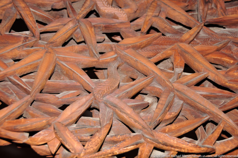 Extreme close-up of interwoven carved wooden lattice.