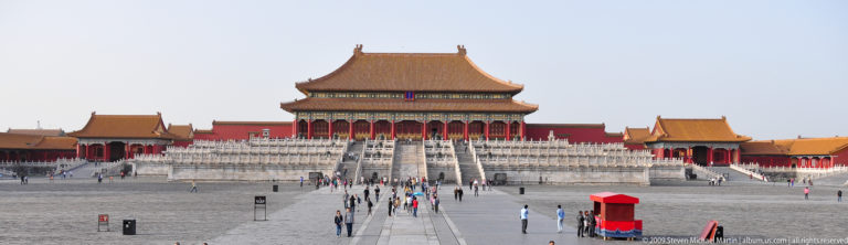 Frontal view of the Hall of Supreme Harmony across its courtyard in the Forbidden City, with visitors walking along the central pathway.